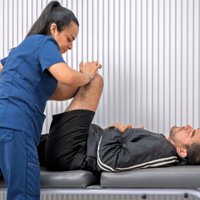 Sports physical therapist treating athlete's chronic pain